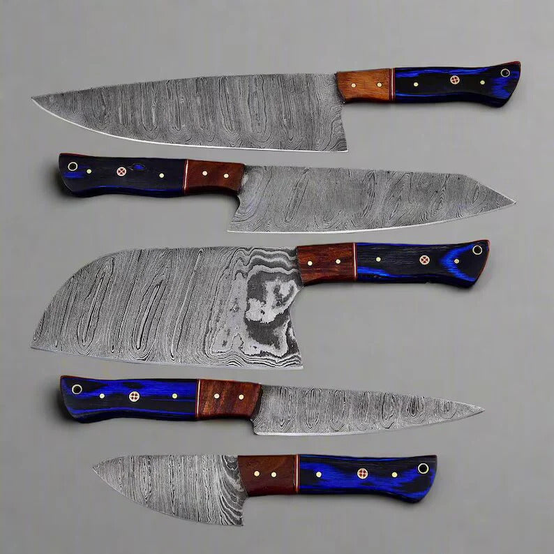 Set of five knives with Damascus steel blades and multicolored handles on a gray background