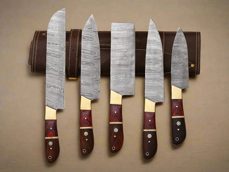 Set of five Damascus knives with wooden handles on a leather belt against a beige background