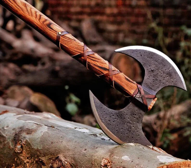 Double Headed Berserker Axe with a metallic head on a log against a natural background