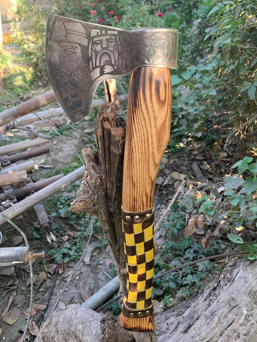 Decorative Fenrir Viking Axe with wooden handle and metal head on a natural background