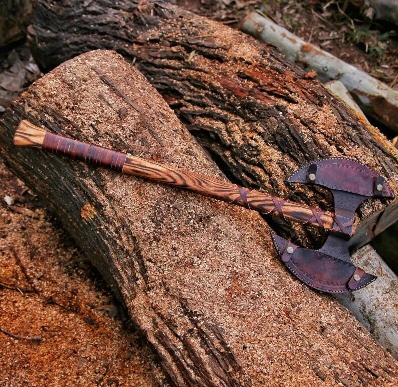 Double Headed Berserker Axe with wooden handle and metal head on a wooden surface