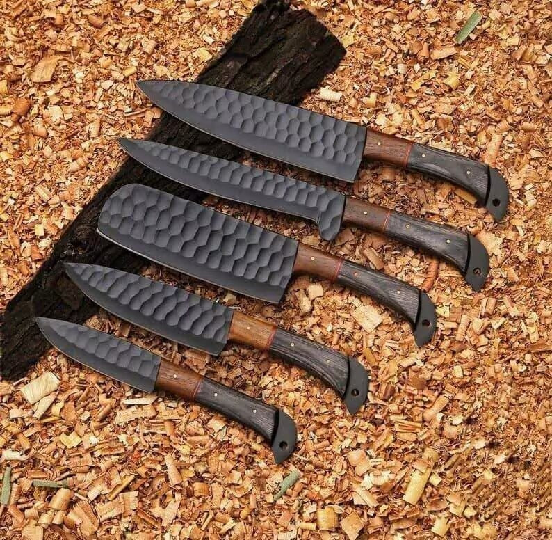 Set of knives with wooden handles on a wooden surface