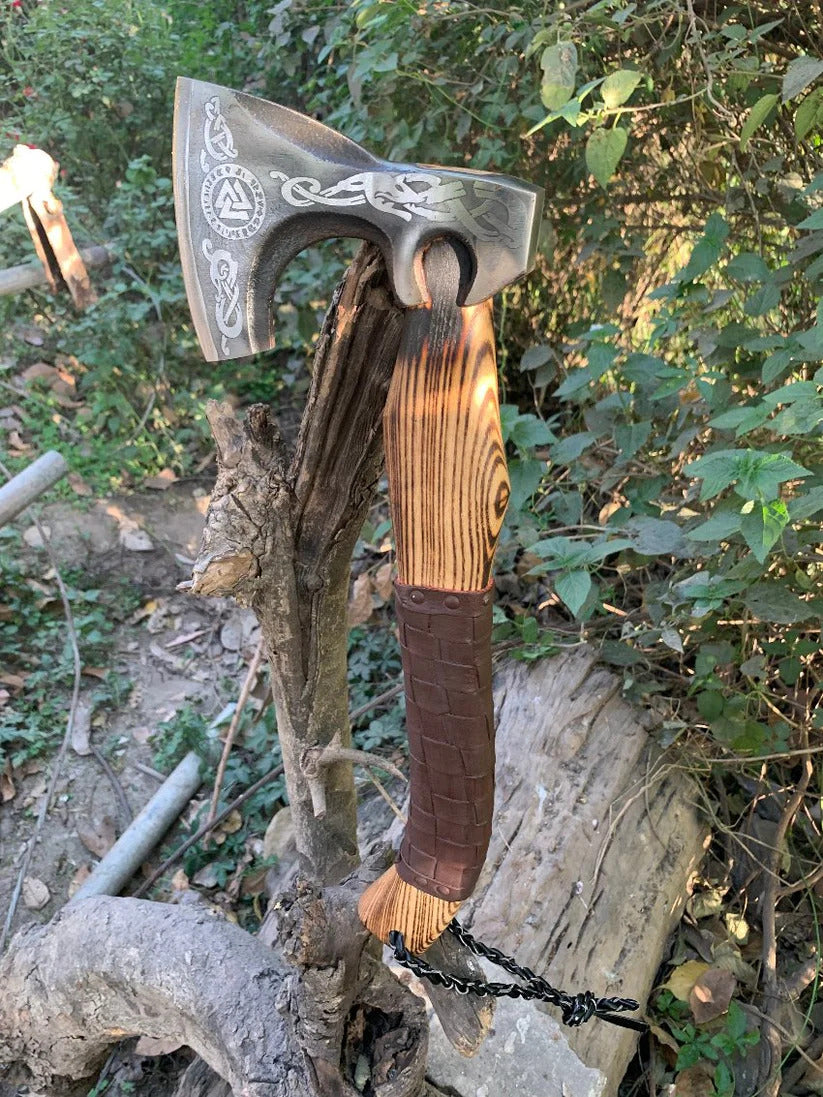 Valknut Viking Axe with wooden handle and metal head on a natural background