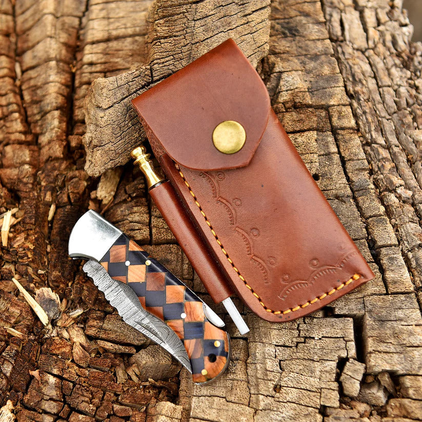 Knife with leather sheath on a wooden background