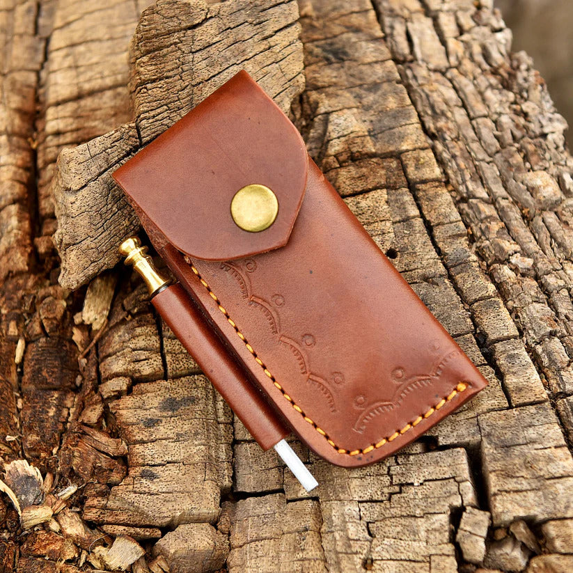 Brown leather pouch with a pen on a wooden surface