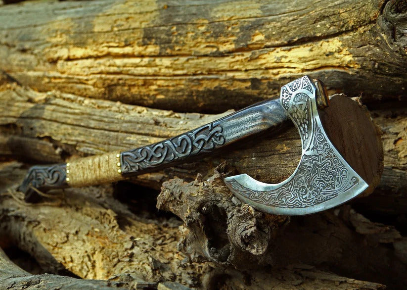 Decorative axe with intricate designs on a wooden background