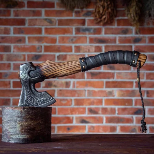 Decorative Hatchet breaded axe with wooden handle and metal head on a stand against a brick wall.