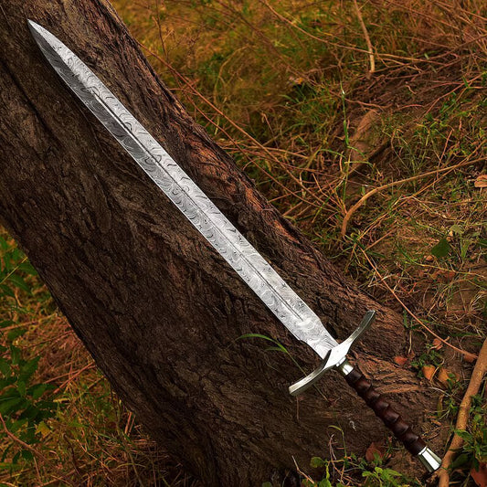 Decorative sword leaning against a tree in a natural setting