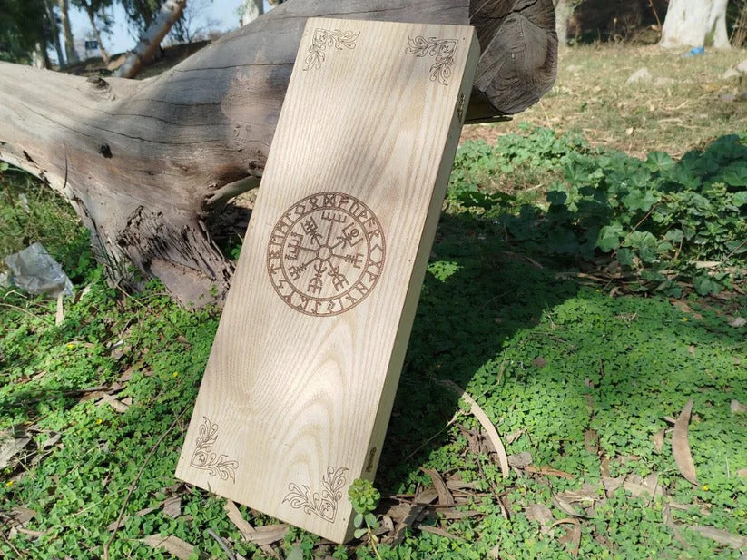 Wooden plaque with engraved design on grass