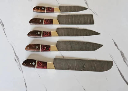 Set of four knives with decorative handles on a marble surface