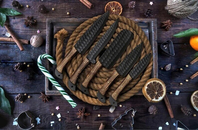 Set of knives wrapped in rope on a wooden surface with decorative elements