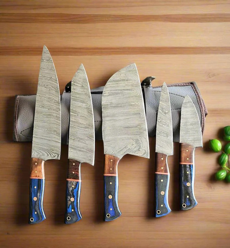 Set of five knives with wooden handles on a wooden surface