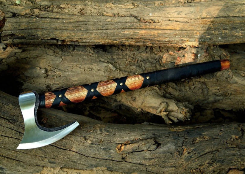 Decorative Norse Durable Axe with a wooden handle on a wooden background