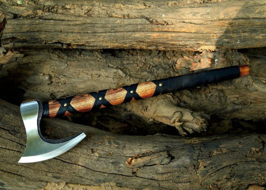 Decorative Norse Durable Axe with a wooden handle on a wooden background