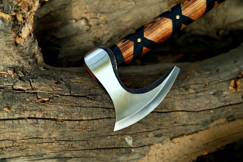 Wooden-handled Norse Durable Axe with a metallic blade on a wooden surface
