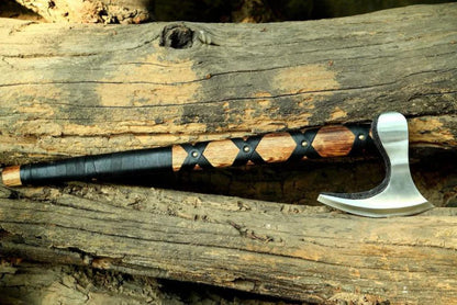 Decorative Norse Durable Axe with wooden handle on a wooden surface