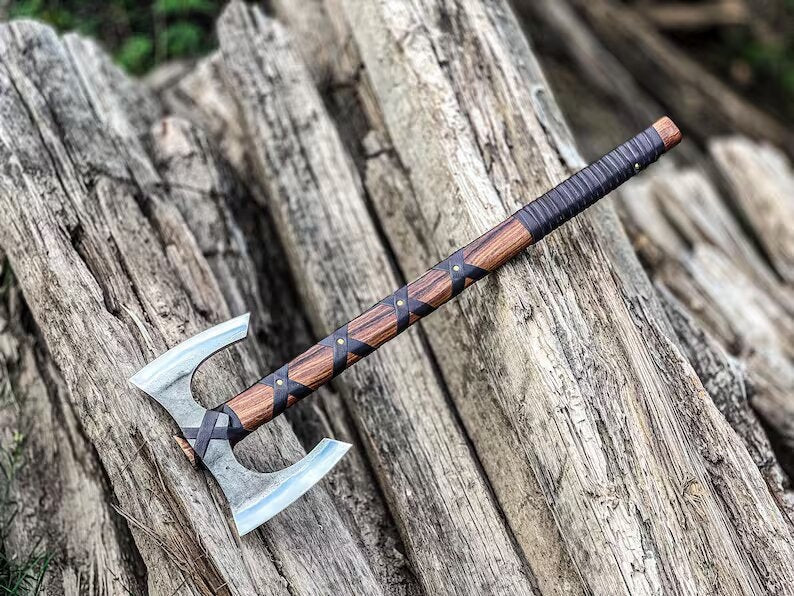 Decorative axe with wooden handle on a wooden surface