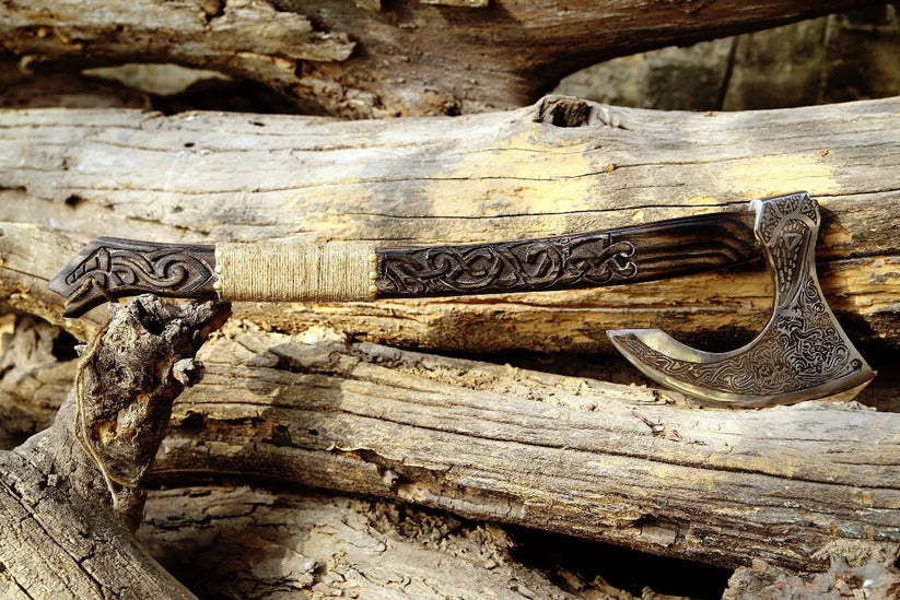 Decorative axe with intricate designs on a wooden background