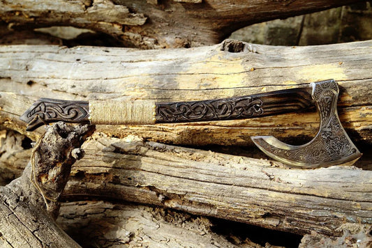 Decorative axe with intricate designs on a wooden background