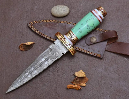 Decorative knife with turquoise handle and gold accents on a brown surface
