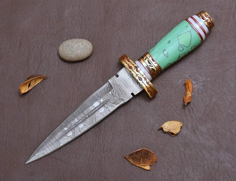 Decorative blue resin  knife with a turquoise handle on a textured surface