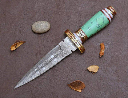 Decorative blue resin  knife with a turquoise handle on a textured surface