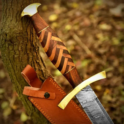 Wooden sword with gold blade and leather sheath against a natural background