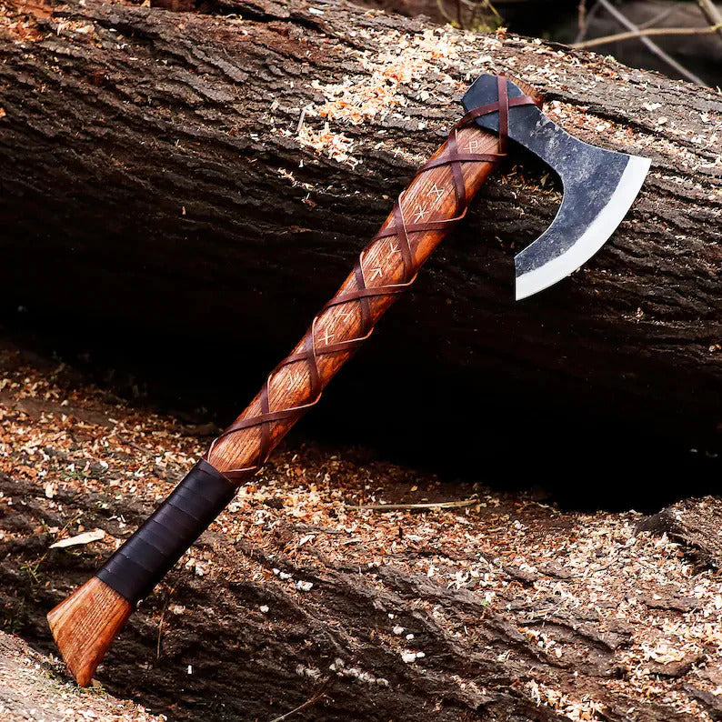 Decorative Authentic Handmade Viking Axe with a wooden handle and metal head on a wooden surface