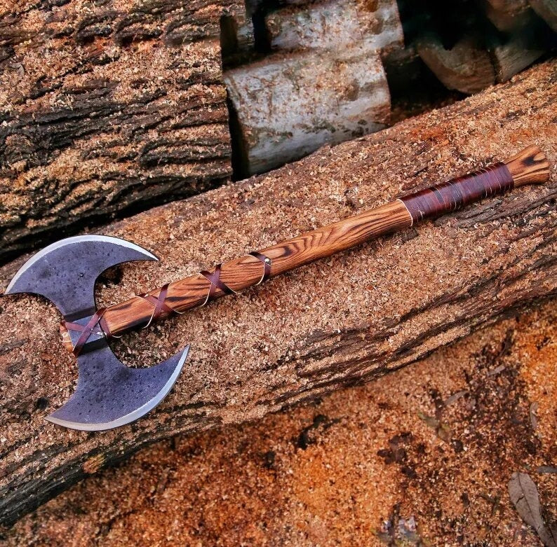 Double Headed Berserker Axe with wooden handle on a wooden surface