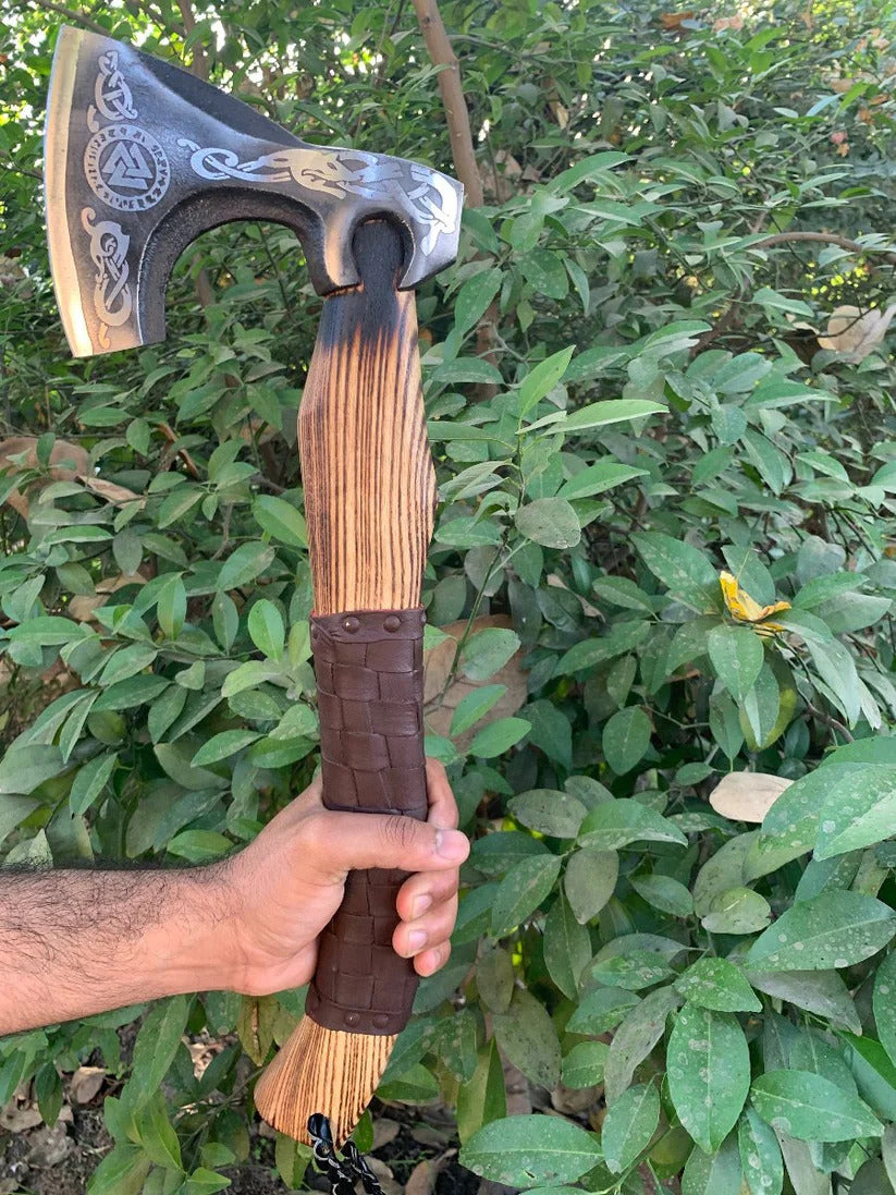  Valknut Viking Axe against a green leafy background.