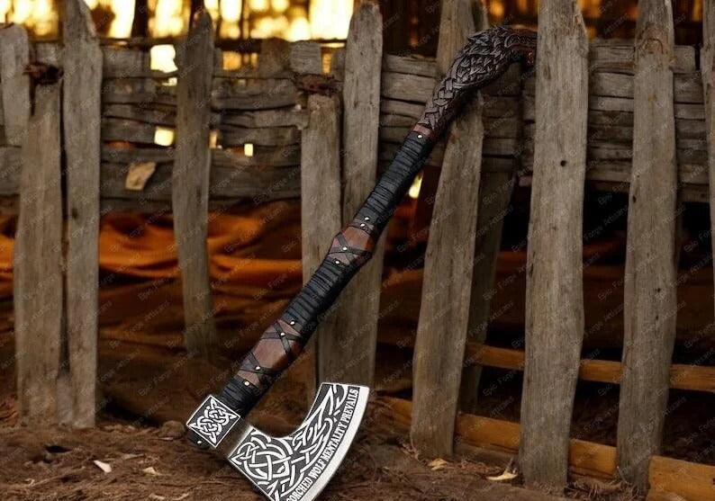 Decorative wolf  axe with intricate designs against a rustic wooden background